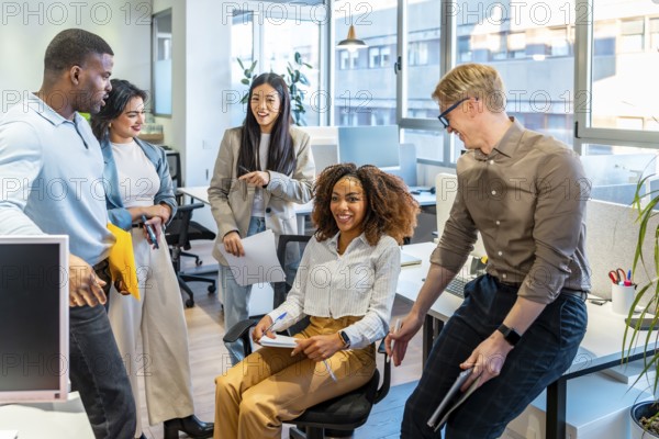 Diverse colleagues engaging in teamwork, sharing ideas, and working together in a modern coworking space