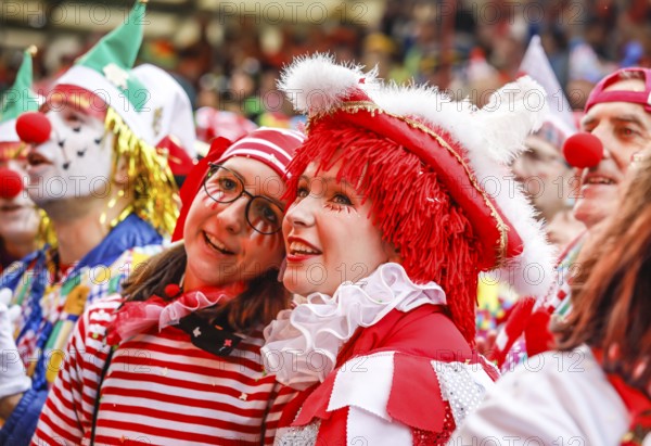 Colourfully costumed carnivalists celebrate carnival in Cologne, on Weiberfastnacht the street carnival is traditionally opened on the Alter Markt, which then reaches its climax on Rosenmontag, Cologne, Rhineland, North Rhine-Westphalia, Germany, Europe