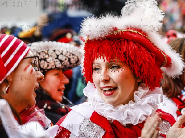 Colourfully costumed carnivalists celebrate carnival in Cologne, on Weiberfastnacht the street carnival is traditionally opened on the Alter Markt, which then reaches its climax on Rosenmontag, Cologne, Rhineland, North Rhine-Westphalia, Germany, Europe