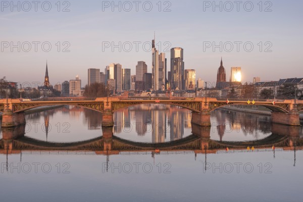 The Frankfurt bank skyline is reflected in the Main River in the morning, shortly after sunrise, Frankfurt am Main, Hesse, Germany, Europe