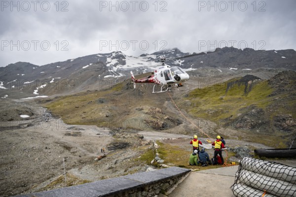 Air rescue operations in the mountains, rescue helicopter, Valais, Switzerland, Europe