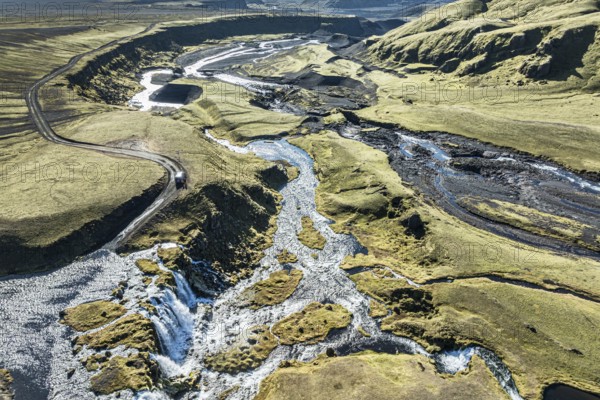 Road F232 Öldufellsleid, along northern slopes of glacier Myrdalsjökull, moss-covered hills in black lava sand, Iceland, Europe