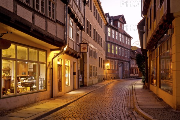 Half-timbered houses in a narrow street with cobblestones, Old Town in the evening, World Heritage City of Quedlinburg, Saxony-Anhalt, Germany, Europe