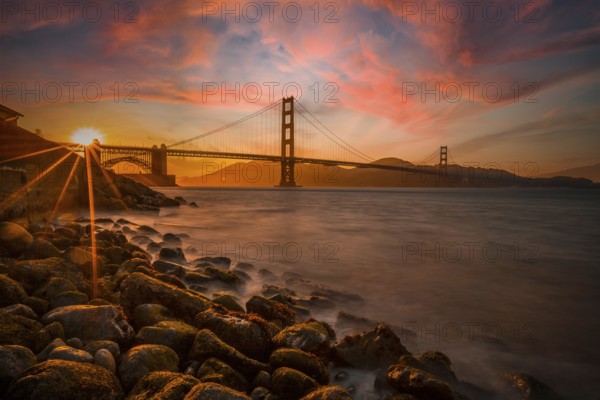 Gorgeous orange sunset with pink clouds over the Golden Gate in San Francisco, California. United States