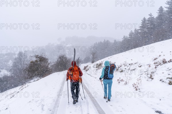 A couple of skiers on Mount Aizkorri in Gipuzkoa. Snowy landscape by winter snows. Basque Country, Spain, Europe