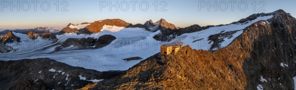 Atmospheric sunrise in a picturesque mountain landscape, alpenglow, aerial view, mountain hut Becherhaus at the summit Becher and glacier Übeltalferner, Stubai Alps, South Tyrol, Italy, Europe