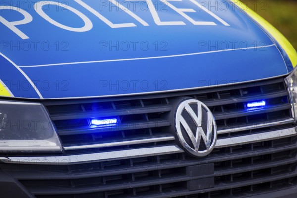 Police car with flashing blue lights in action