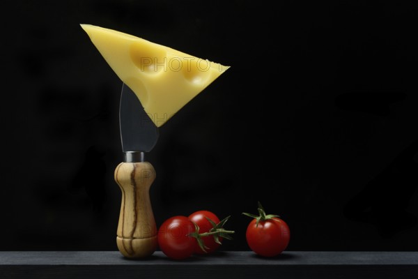 A piece of Swiss Emmental cheese on a cheese knife