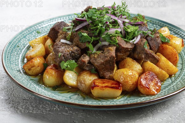 Kuyrdak, roast offal with potatoes and fresh herbs, homemade in Kazakh, no people