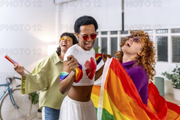 Happy multiracial and gender diverse lgbt people dancing an partying at home