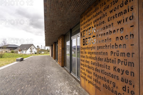 New multi-purpose hall, Keyenberg community centre, with Corten steel panels on the village history, in the resettlement site of the 5 villages from the Garzweiler II opencast lignite mining area, Keyenberg, Kuckum, Oberwestrich, Unterwestrich, Berverath, which were originally to be dug up but will now remain due to the lignite phase-out in 2030, around 60% of the former inhabitants of the villages live here in the new location on 56 hectares, in the north of Erkelenz, North Rhine-Westphalia, Germany, Europe