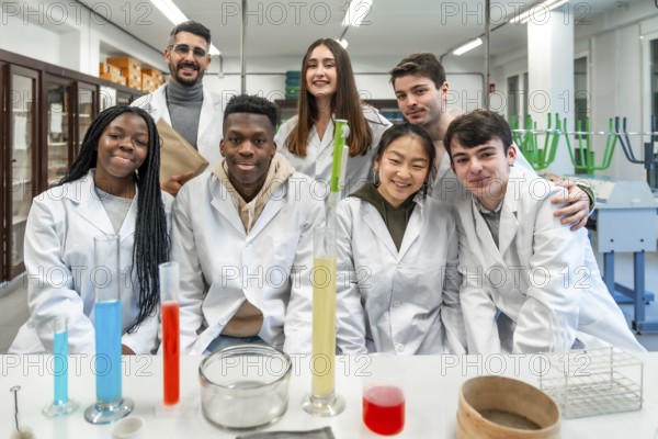 Group of diverse university students and their teacher posing together in a chemistry laboratory, showcasing teamwork and scientific exploration
