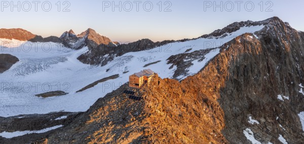 Atmospheric sunrise in a picturesque mountain landscape, alpenglow, aerial view, mountain hut Becherhaus at the summit Becher and glacier Übeltalferner, Stubai Alps, South Tyrol, Italy, Europe