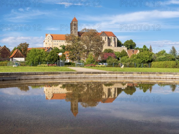 Castle hill with collegiate church of St. Servatius with reflection in water basin in autumn, UNESCO World Heritage Site, Quedlinburg, Saxony-Anhalt, Germany, Europe