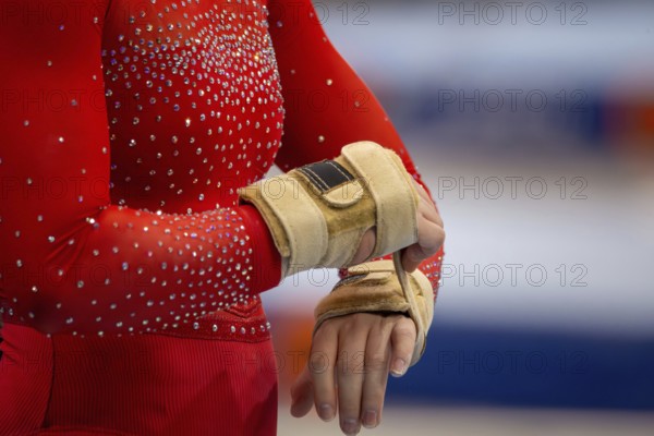 Symbolic image of apparatus gymnastics: close-up of a gymnast putting on her straps
