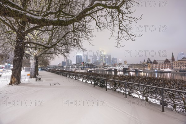 The skyscrapers of Frankfurt's banking skyline rise up from the snow-covered city centre into the low-hanging cloud cover. Frankfurt am Main, Hesse, Germany, Europe