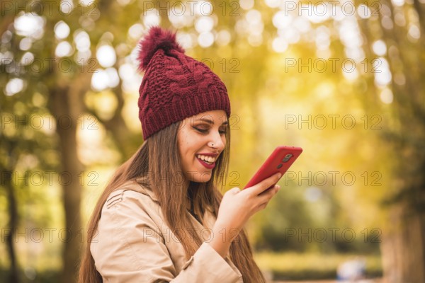 Portrait of a beautiful woman in autumn together in a forest in nature on a video call
