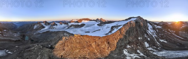 DefaultAtmospheric sunrise in a picturesque mountain landscape, alpenglow, aerial view, mountain hut Becherhaus at the summit Becher and glacier Übeltalferner, Stubai Alps, South Tyrol, Italy, Europe