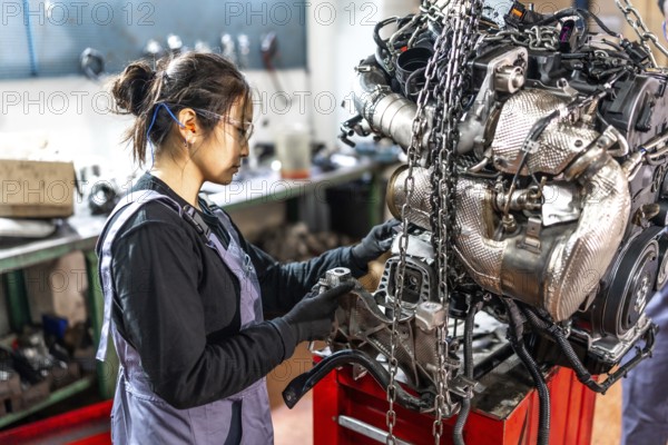 Skilled mechanic assembling engine parts in a professional workshop, showcasing expertise and precision in automotive repair