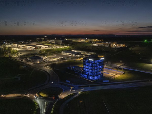 Illuminated industrial building at night in a rural setting, Nagold, Black Forest, Germany, Europe