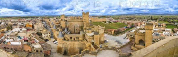Panoramic view of the medieval royal palace of olite, a stunning example of gothic architecture, overlooking the picturesque town of olite in navarre, spain