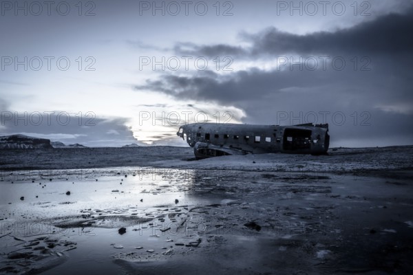 Plane wreck, crahsed plane on frozen Solheimasandur beach in winter with snow in Iceland