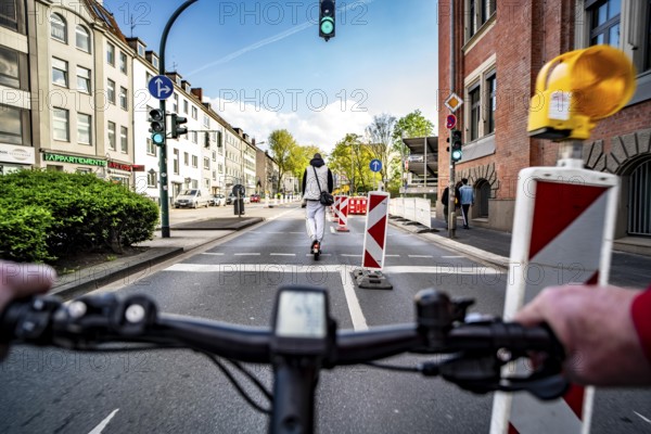 Cycling in the city, city centre road, roadworks, no cycle path, two-lane traffic in both directions, cyclists' perspective, Essen, North Rhine-Westphalia, Germany, Europe