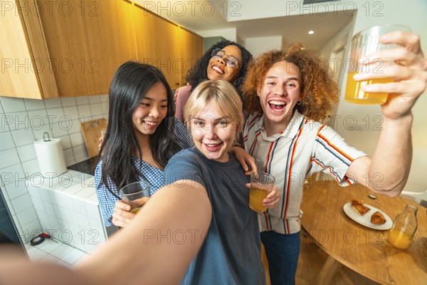 Group of cheerful young multi ethnic friends taking selfie while drinking juice and smiling in kitchen
