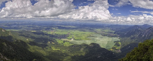 Panoramic view from Herzogstand down to a mountain landscape with Lake Kochel and cloudy sky, Kochel am See, Bavaria, Germany, Europe