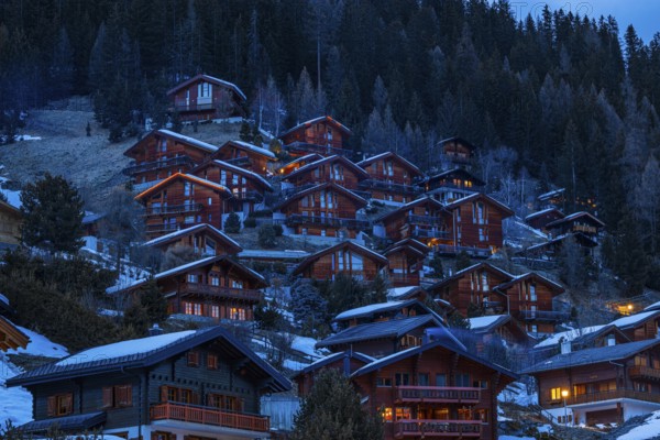 Chalets built into the hillside as holiday homes at dusk, Grimentz, Val d'Anniviers, Valais Alps, Canton Valais, Switzerland, Europe