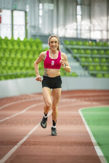 View of the running track in a large, empty stadium from above, with green seats and no people, Glaspalast, Sindelfingen, Germany, Europe