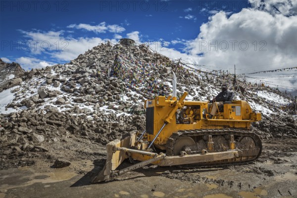 KHARDUNG LA PASS, INDIA, SEPTEMBER 12, 2012: Road construction at Kardung La, the highest motorable highest vehicle-accessible pass pass (5602 m) in the world. The pass is strategically important to India as it is used to carry supplies to the Siachen Glacier