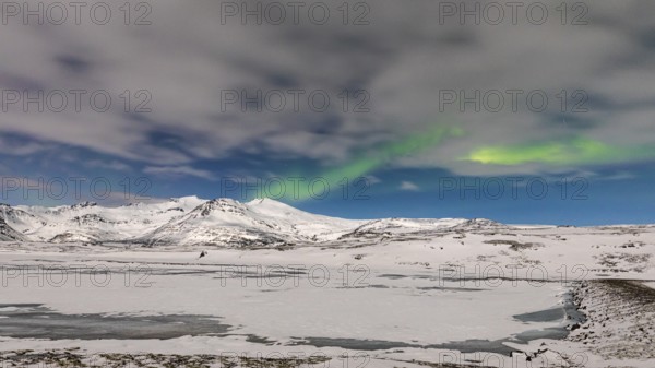 Northern Lights, Aurora Borealis, over snow-covered landscape at Skalafellsjökull, Sudurland, Iceland, Europe