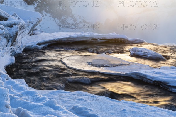 The morning sun reflected in the river Skjalfandafljot, snow-covered landscape, Northern Iceland Eyestra, Iceland, Europe