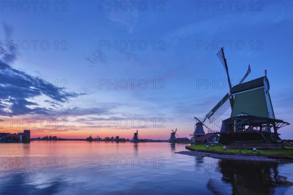 Netherlands rural scene, windmills at famous tourist site Zaanse Schans in Holland on sunset with dramatic sky. Zaandam, Netherlands