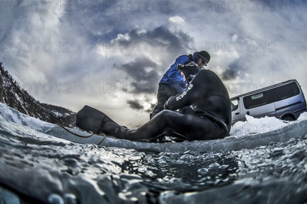 Scuba diver on the ice, Lake Baikal, Olkhon Island, Pribaikalsky National Park, Irkutsk Province, Siberia, Russia, Europe