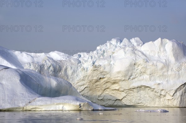 Giant iceberg in the glow of the midnight sun Disko Bay, Ilulissat, Arctic, Greenland, Denmark, North America
