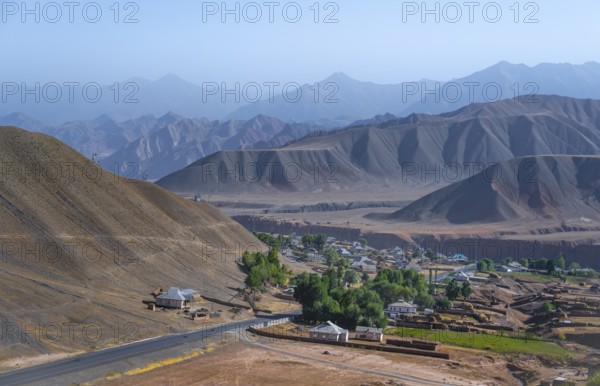 Small village Toktogul between dry mountain landscape, Kyrgyzstan, Asia