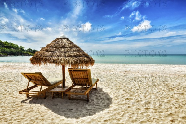 Vacation holidays background wallpaper, two beach lounge chairs under tent on beach. Sihanoukville, Cambodia, Asia