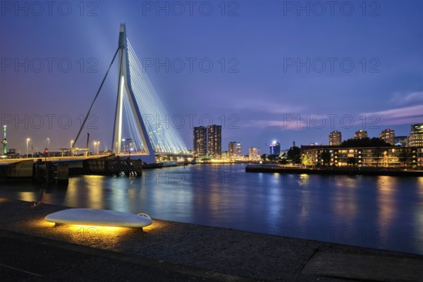 Erasmus Bridge (Erasmusbrug) and Rotterdam skyline illuminated at night. Rotterdam, Netherlands