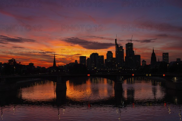 The silhouette of Frankfurt's banking skyline stands out against the luminous evening sky in the evening after sunset., Frankfurt am Main, Hesse, Germany, Europe