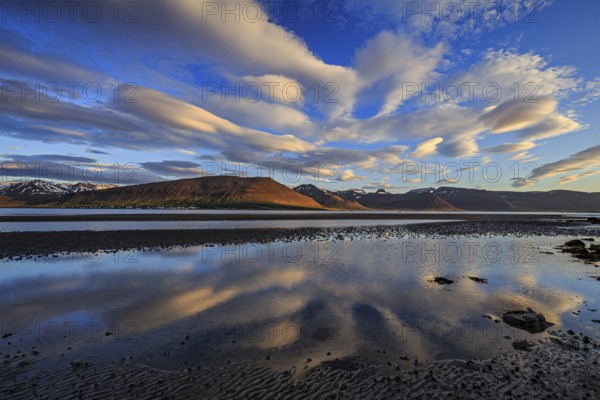 Ebb pond at a fjord off Bergen, evening light, clouds reflected in the water, Westfjords, Iceland, Europe