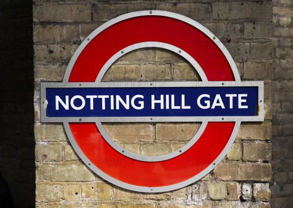 Sign on brick wall, Notting Hill Gate underground station, SLondon, England, Great Britain