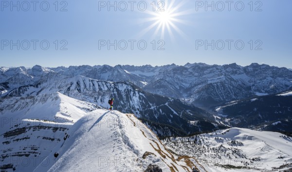 Ski tourers at the summit of Schafreuter, view of snowy mountain panorama, Sonnenstern, Karwendel, Tyrol, Austria, Europe