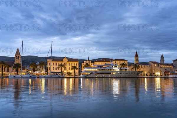 Cruise ship in front of the old town centre of Trogir at dusk, Croatia, Europe