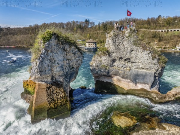 Aerial view of the Rhine Falls at low water in spring, with tourists on the viewing platform, in the centre the panorama restaurant Schlössli Wörth, Neuhausen, Canton Schaffhausen, Switzerland, Europe