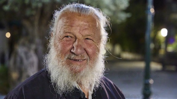 Papas Vaianos, Pope in Psinthos, An elderly man with a white beard smiles outdoors at night, Easter bonfire Psinthos, Holy Saturday, Easter, Psinthos, Rhodes, Dodecanese, Greek Islands, Greece, Europe