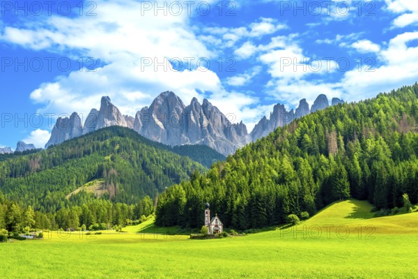 Scenic summer view of the idyllic alpine valley of val di funes with st. Magdalena church and the odle mountain range in the italian dolomites