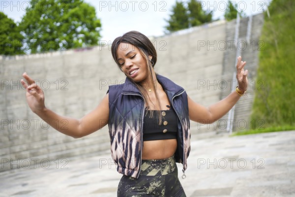 Latin beauty woman gesturing gentile dancing salsa in a park