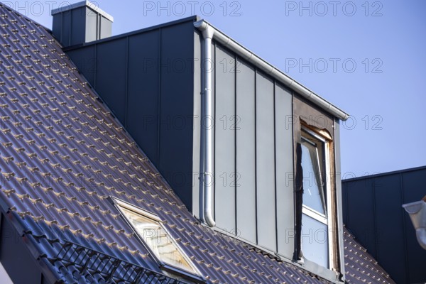 Extension of living space by installing a dormer window: Newly installed dormer window on a newly tiled roof